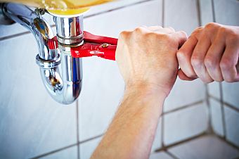 Mike is fixing a clogged kitchen drain