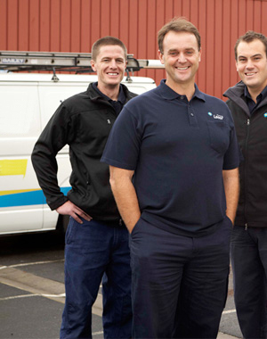 three of our plumbers in Aventura, FL standing by their truck